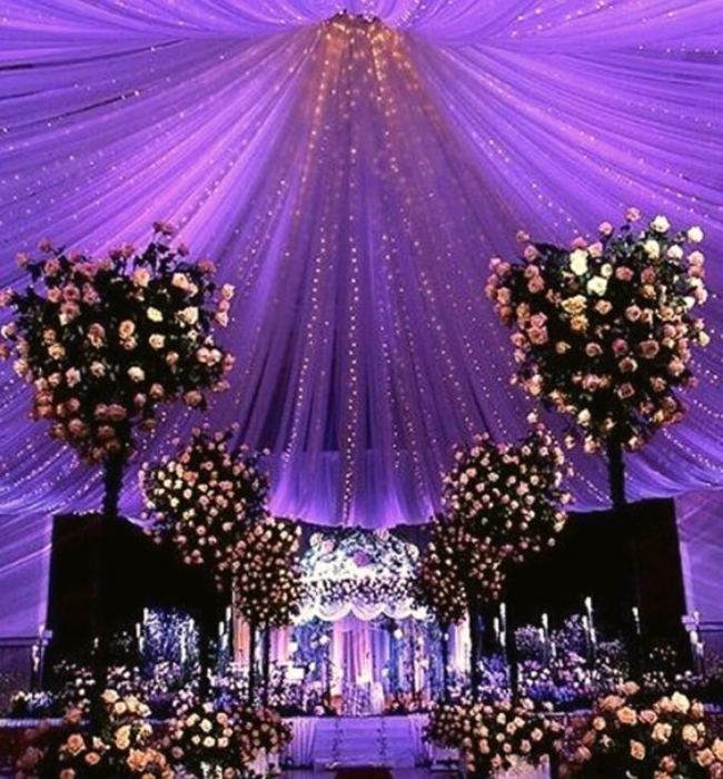 Accentuate Sheer Drapery Panels Hanged On High Ceilings | 21 Stunning Wedding Lighting Ideas Using Festoon And Fairy Lights