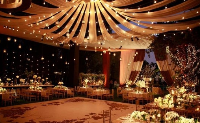 Maypole Style Drapes In between wedding lighting ideas