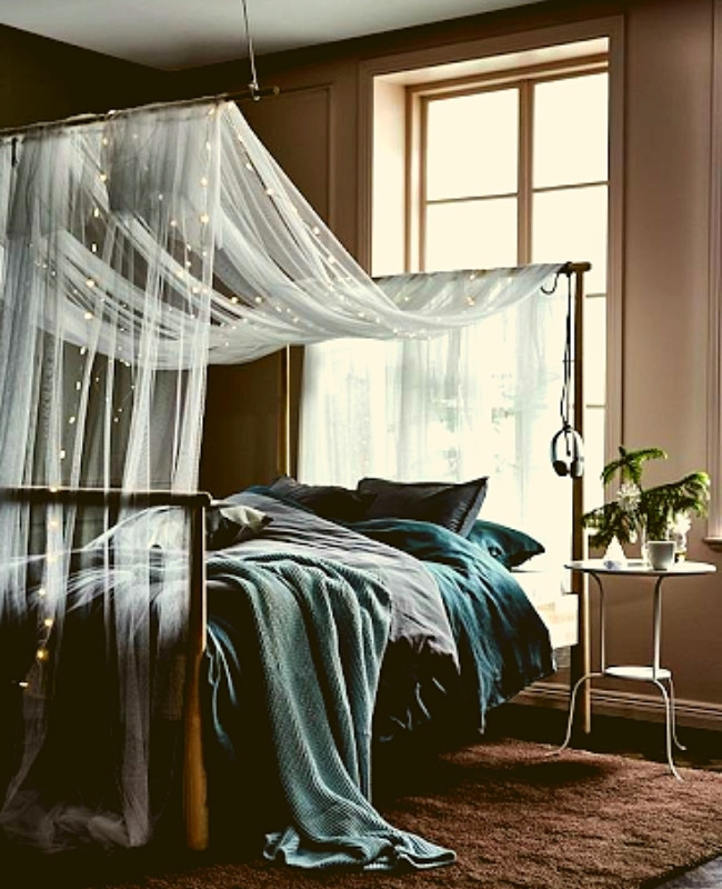 sheer curtains and strings lights hanged on top of the bed | fairy light ideas