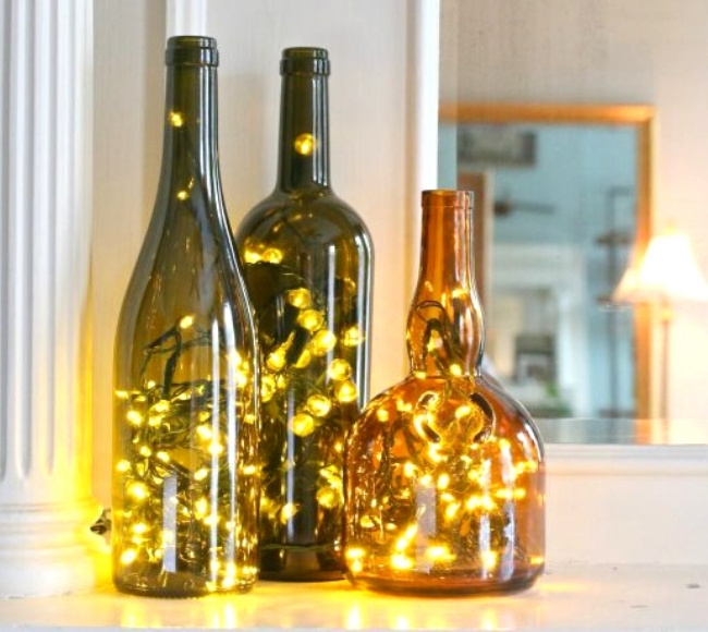 fairy lights placed inside empty wine bottles