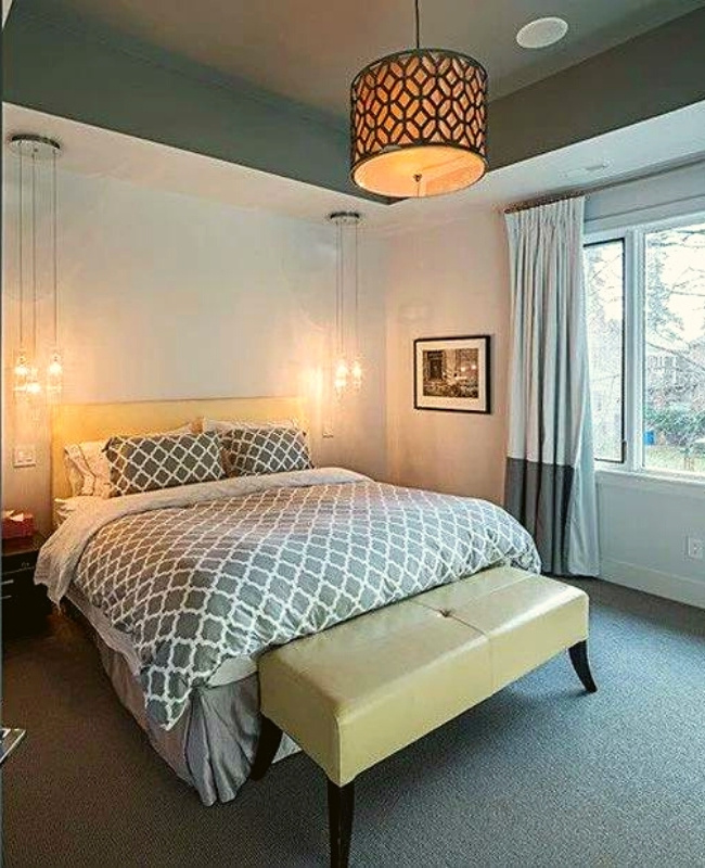 pendant lights with patterned design hanging on top of the edge the bed