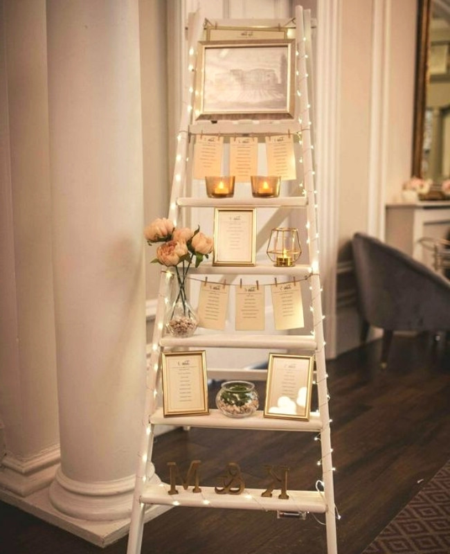 repurposed ladder used as shelf with fairy lights