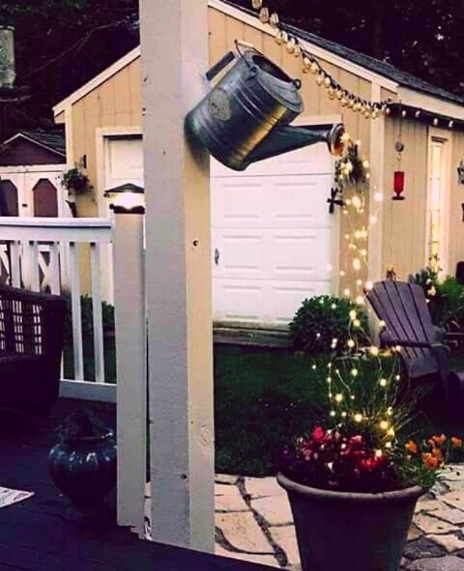 refurbished old watering can made into a sparkling outdoor | fairy light ideasdecor