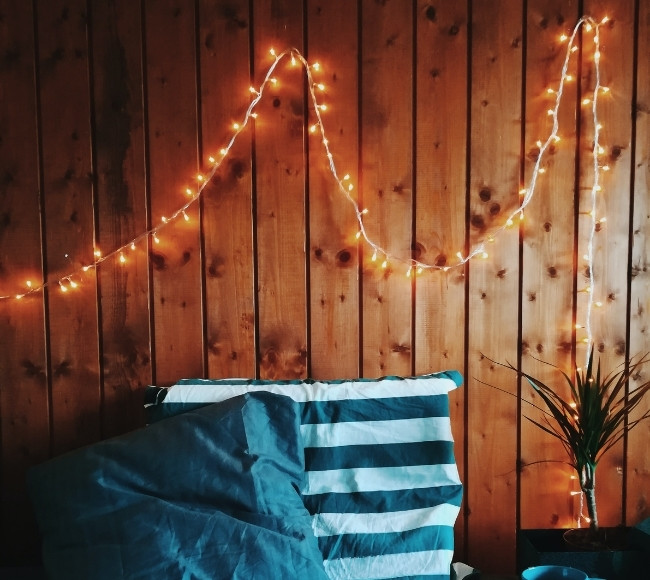 what are fairy lights hanging on wooden wall