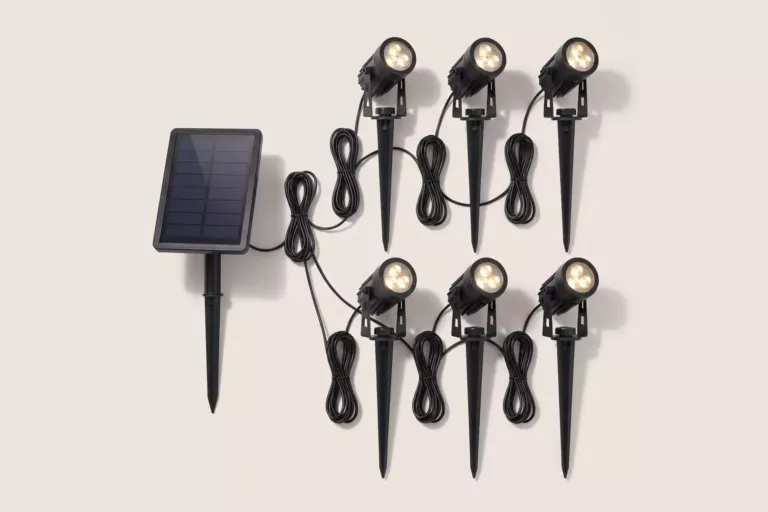 Six head solar spot light kit laid out with its separate solar panel, ground spikes and connecting cables